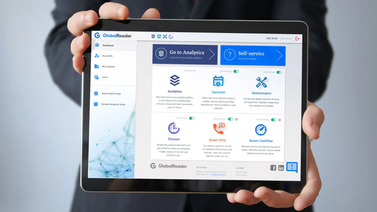Person holding a tablet displaying a dashboard with analytics, operator, maintenance, planner, smart help, and smart LiveView options.
